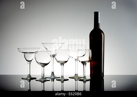 An arrangement of assorted wine glasses and a wine bottle. Stock Photo