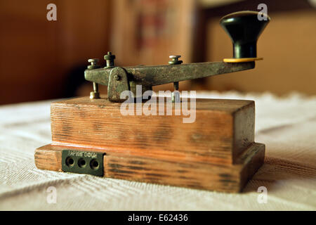 An old Russian straight key device for Morse code sending applications in closeup Stock Photo