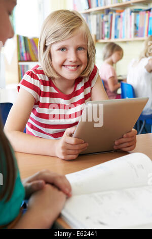 Elementary School Pupil Using Digital Tablet In Classroom Stock Photo