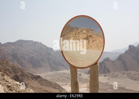Traffic mirror reflects the mountain region of Musandam, Oman Stock Photo