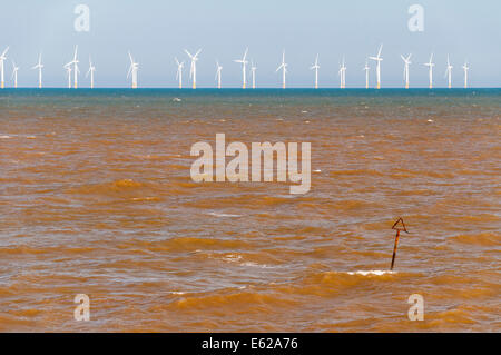 Looking across the sea at Skegness towards an offshore wind farm Stock Photo