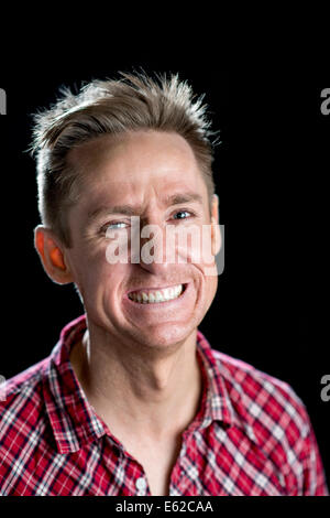 Headshots on black of a good looking man in his thirties with various facial expressions. Stock Photo