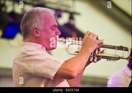 Trumpet player with Township Comets jazz band from South Africa performing on stage at Brecon Jazz Festival 2014 Stock Photo