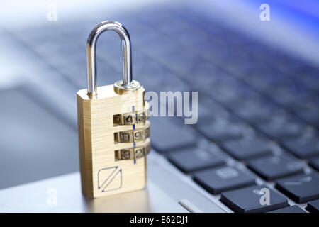 A combination padlock on a laptop keyboard Stock Photo