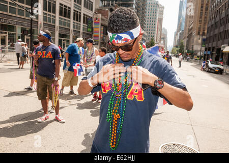 Hispanic fraternity member from Phi Iota Alpha adjusts his beads in the 33rd Annual Dominican Day Parade in New York Stock Photo