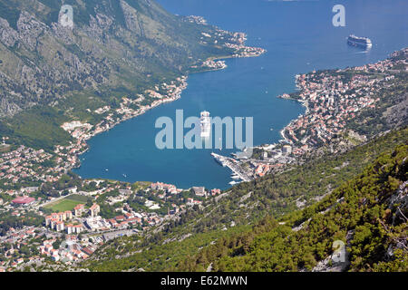 Aerial landscape & view looking down town & Bay of Kotor cruise ships Regal Princess & Celebrity Silhouette moored off shore Montenegro Adriatic Sea Stock Photo