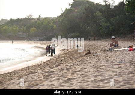 A traveller on Om Beach in Gokarna, India Stock Photo