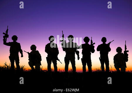 silhouette of  Soldiers team with sunrise background Stock Photo