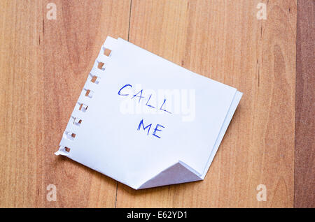 Call Me Note on the wooden desk Stock Photo