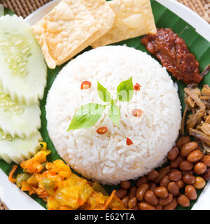 Nasi lemak, a traditional malay curry paste rice dish served on a banana leaf Stock Photo