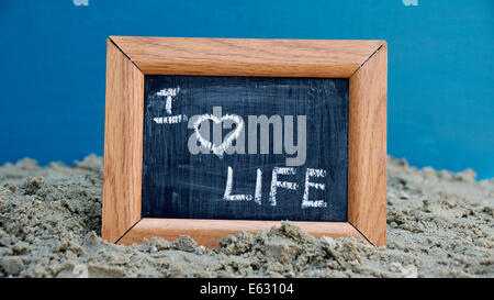 I love life written on a chalkboard at the beach Stock Photo