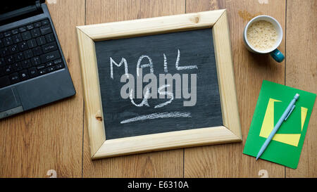 Mail us written on a chalkboard at the office Stock Photo