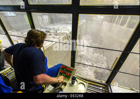 A crane operator is supervising the transport of waste to the incinerators in a waste incineration plant, Essen-Karnap Stock Photo