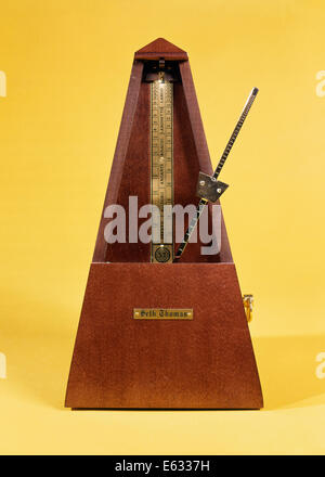 WOODEN AND BRASS METRONOME Stock Photo