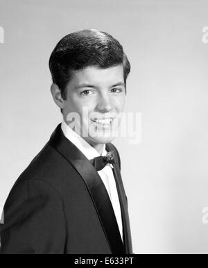 1960s PORTRAIT SMILING TEENAGE BOY WEARING A TUXEDO LOOKING AT CAMERA Stock Photo