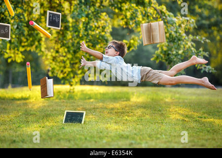 Thirst for knowledge, flying cute little boy Stock Photo