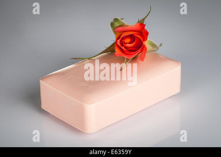 Pink soap with rose flower on gray background Stock Photo