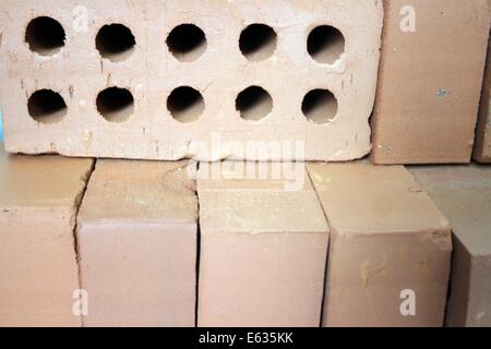 Dhaka 13 August 2014. Pile of red cavity bricks. Stock Photo