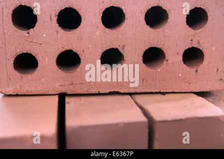 Dhaka 13 August 2014. Pile of red cavity bricks. Stock Photo