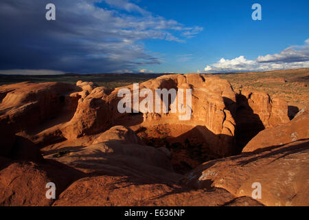 Eroded rock formations near Delicate Arch and approaching storm clouds, Arches National Park, near Moab, Utah, USA Stock Photo