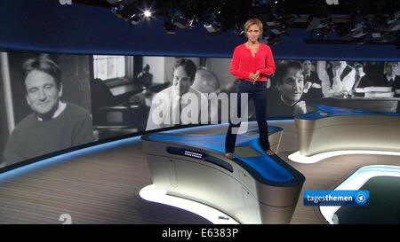 HANDOUT - PICTURE REPEAT WITH BETTER QUALITY - A handout picture provided by German public radio and television broadcaster, Norddeutscher Rundfunk (NDR), shows news anchorwoman Caren Miosga of NDR's Tagesthemen, standing on an anchor table as she commemorates the late US actor Robin Williams on 12 August 2014. In the film 'Dead Poet's Society' from 1989, Williams played the role of a teacher who wanted to inspire his students to think while standing on a table citing Whitman's poem 'O Captain! My Captain!'. 63-year old Williams was found dead in his house in San Francisco on 11 August 2014. P Stock Photo