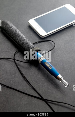 e cigarette and smart phone  on table Stock Photo