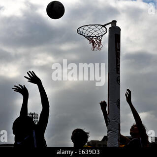 Cape Town, South Africa. 13th Aug, 2014. players are silhouetted against the grey sky during the Spar Women's National Netball Championships held at the Bellville Velodrome, just outside Cape Town. There are 39 teams participating in the event which ends on Saturday 16 August. Credit:  Roger Sedres/Alamy Live News Stock Photo