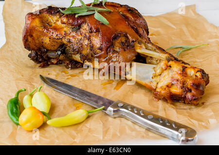 Knuckle baked with a toasted skin, potatoes and chillies Stock Photo