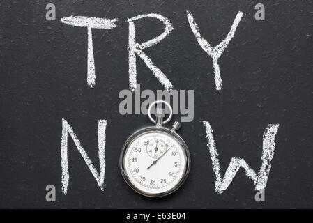 try now concept handwritten on chalkboard with vintage precise stopwatch used instead of O Stock Photo