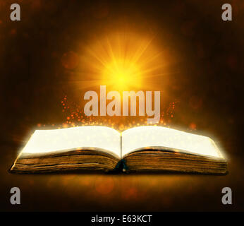 Old book with magic Ray of light Stock Photo