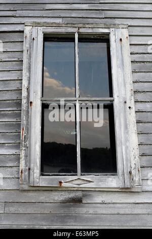 Weather worn window casing on old building in Machais, Maine. Stock Photo