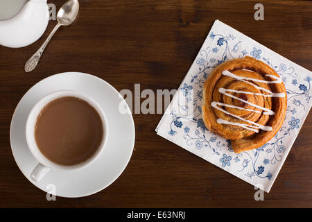 Tea and tempting cinnamon roll from above. Stock Photo