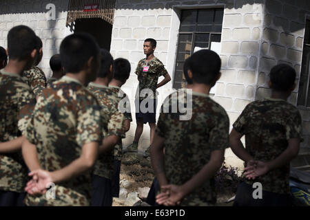 Laiza, Kachin, Myanmar. 8th July, 2014. KIA recruits wait at attention as cleaning assignments are given out at a training camp. (Credit Image: © Taylor Weidman/zReportage.com via ZUMA Press) Stock Photo