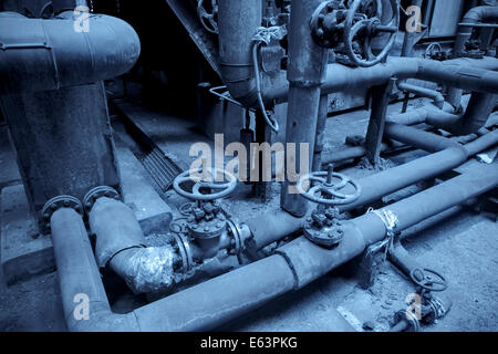 Pipes and valves in the factory,blue toned Stock Photo