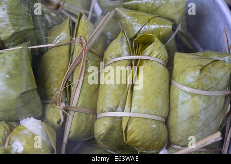 closeup of glutinous rice steamed in banana leaf in steam pot ; selective focus with blur background Stock Photo