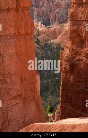 Hiker on Navajo Loop trail through hoodoos, Bryce Canyon National Park, Utah, USA Stock Photo