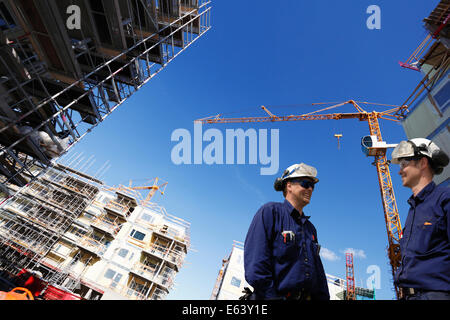 construction industry and two building workers in hard-hats Stock Photo
