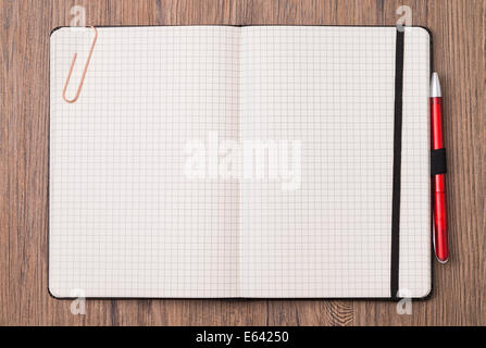 Image shows an empty notebook opened on wood-ground Stock Photo