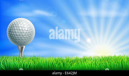 A golf ball on its tee in a green grass field golf course with sun rising. Stock Photo