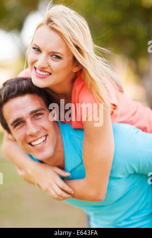 Girlfriend enjoying the ride on her boyfriend's back Stock Photo - Alamy