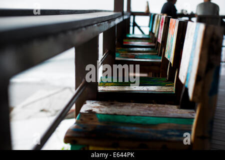 Row of chairs in a beach front restaurant Stock Photo
