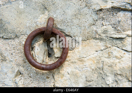 Old rusty ring in a wall in france Stock Photo