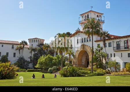 People sit on a neatly manicured green lawn in front of Santa Barbara County Courthouse. Santa Barbara, California, USA. Stock Photo