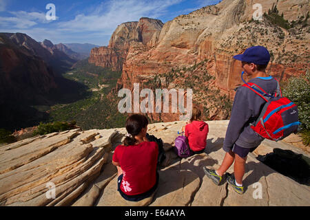 Family of hikers looking down on Zion Canyon and Virgin River, from the top of Angel's Landing, Zion National Park, Utah, USA Stock Photo