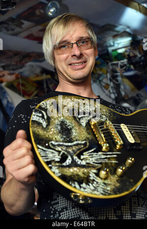 Berlin, Germany. 08th Aug, 2014. EXCLUSIVE - Music producer, guitar designer and owner of MSP guitars, Martin Schlechta, poses in his music studio in Berlin, Germany, 08 August 2014. He designs unusual electric guitars, which use his own design for pick-ups and other electronics that give them a special sound. He designs all of the guitars individually with special surfaces made from leather, rhinestones or brass inlays. He cooperates with Sido, Marcia Barrett and Jennifer Rush. Photo: JENS KALAENE/dpa/Alamy Live News Stock Photo