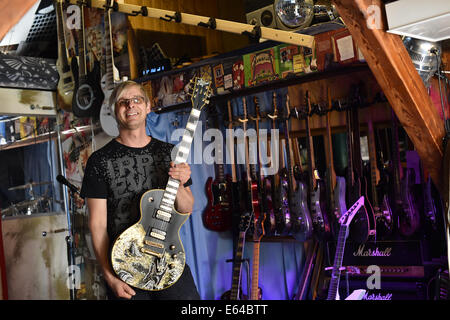 Berlin, Germany. 08th Aug, 2014. EXCLUSIVE - Music producer, guitar designer and owner of MSP guitars, Martin Schlechta, poses in his music studio in Berlin, Germany, 08 August 2014. He designs unusual electric guitars, which use his own design for pick-ups and other electronics that give them a special sound. He designs all of the guitars individually with special surfaces made from leather, rhinestones or brass inlays. He cooperates with Sido, Marcia Barrett and Jennifer Rush. Photo: JENS KALAENE/dpa/Alamy Live News Stock Photo