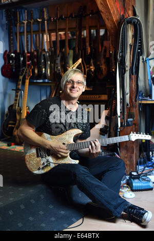 Berlin, Germany. 08th Aug, 2014. EXCLUSIVE - Music producer, guitar designer and owner of MSP guitars, Martin Schlechta, poses in his music studio in Berlin, Germany, 08 August 2014. He designs unusual electric guitars, which use his own design for pick-ups and other electronics that give them a special sound. He designs all of the guitars individually with special surfaces made from leather, rhinestones or brass inlays. He cooperates with Sido, Marcia Barrett and Jennifer Rush. Photo: JENS KALAENE/dpa/Alamy Live News Stock Photo