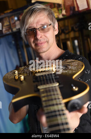 Berlin, Germany. 08th Aug, 2014. EXCLUSIVE - Music producer, guitar designer and owner of MSP guitars, Martin Schlechta, poses in his music studio in Berlin, Germany, 08 August 2014. He designs unusual electric guitars, which use his own design for pick-ups and other electronics that give them a special sound. He designs all of the guitars individually with special surfaces made from leather, rhinestones or brass inlays. He cooperates with Sido, Marcia Barrett and Jennifer Rush. Photo: JENS KALAENE/dpa/Alamy Live News Stock Photo