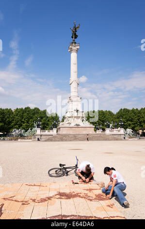 Artists making wine cork mosaic Place des Quinconces, Bordeaux,  Gironde, France, Europe Stock Photo