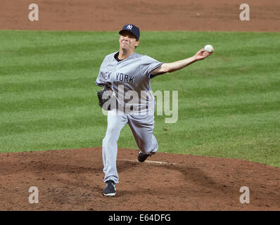 Fly Out To End The Inning. 11th Aug, 2014. New York Yankees pitcher Rich Hill (57) works in the eighth inning inning against the Baltimore Orioles at Oriole Park at Camden Yards in Baltimore, MD on Monday, August 11, 2014. He induced Oriole left fielder Delmon Young to fly out to end the inning. The Orioles won the game 11 - 3. Credit: Ron Sachs/CNP (RESTRICTION: NO New York or New Jersey Newspapers or newspapers within a 75 mile radius of New York City) NO WIRE SERVICE/dpa/Alamy Live News Stock Photo